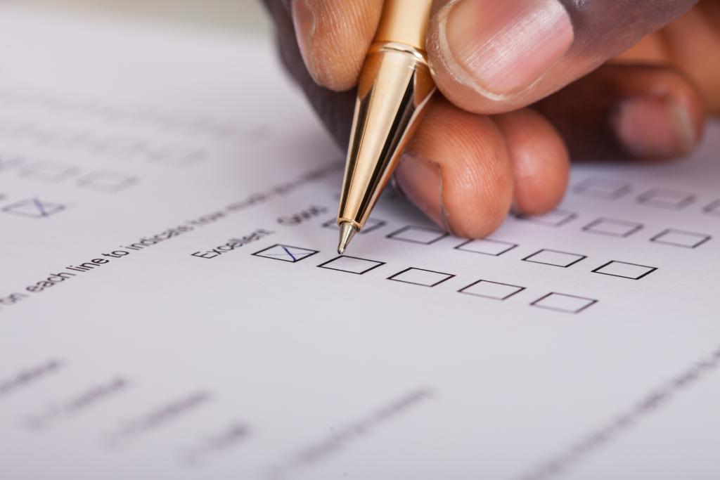 This is a stock photo from iStock showing a person filling out forms. This image is needed for a webpage about filling out personal records requests at DPSS.