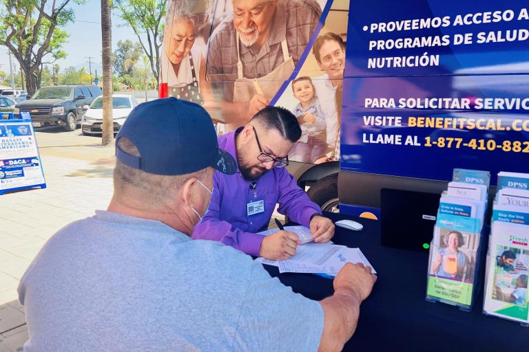 An eligibility technician helps a customer with their Medi-Cal application.