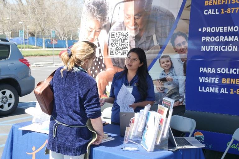 Shelani Villanueva, an eligibility technician at the Riverside County Department of Public Social Services, helps a student at a CalFresh outreach event at Mt. San Jacinto College’s main campus in San Jacinto.