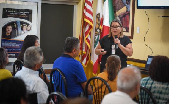 Marivel Castaneda, a senior program specialist at the Riverside County Department of Public Social Services, gives a presentation in Spanish about Medi-Cal’s older adult expansion to dozens of residents at TODEC Legal Center in Perris on Aug. 12, 2022. 