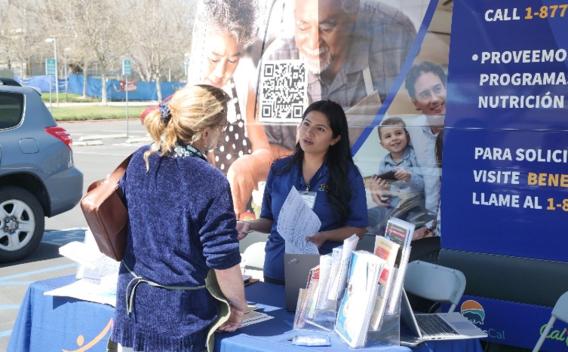 Shelani Villanueva, an eligibility technician at the Riverside County Department of Public Social Services, helps a student at a CalFresh outreach event at Mt. San Jacinto College’s main campus in San Jacinto.